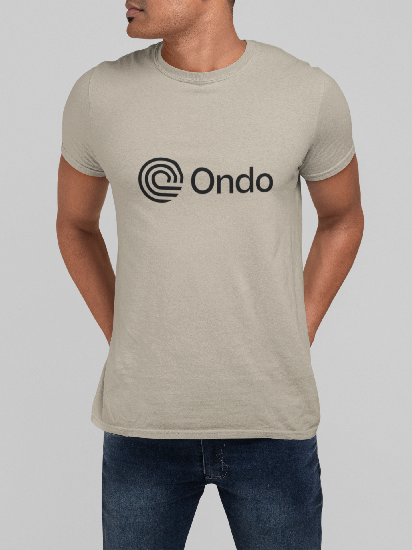 Person wearing a beige t-shirt with 'Ondo' logo on a plain background