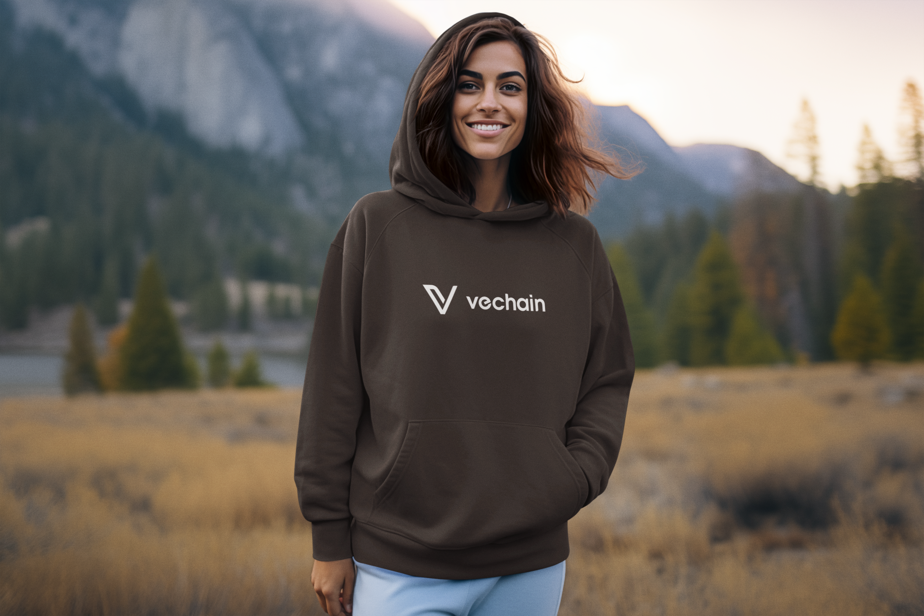 Woman wearing a hoodie with Vechain logo in a mountainous landscape