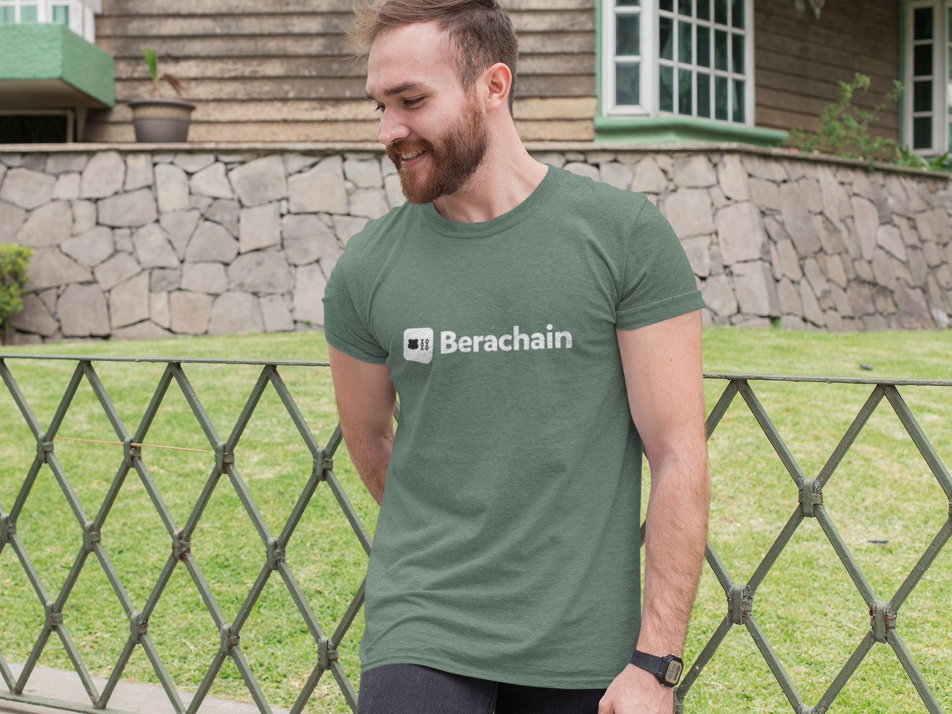 Man wearing a green t-shirt with 'Berachain' logo outdoors.