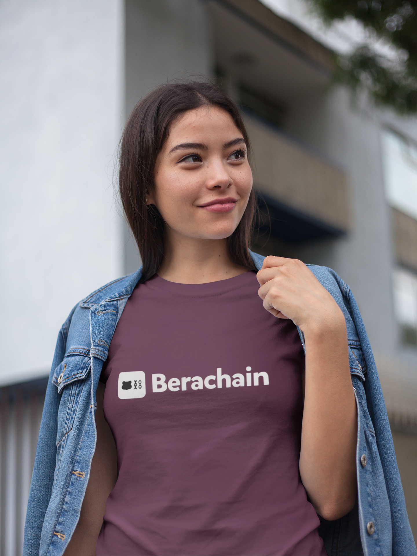 Person wearing a maroon t-shirt with 'Berachain' logo outdoors