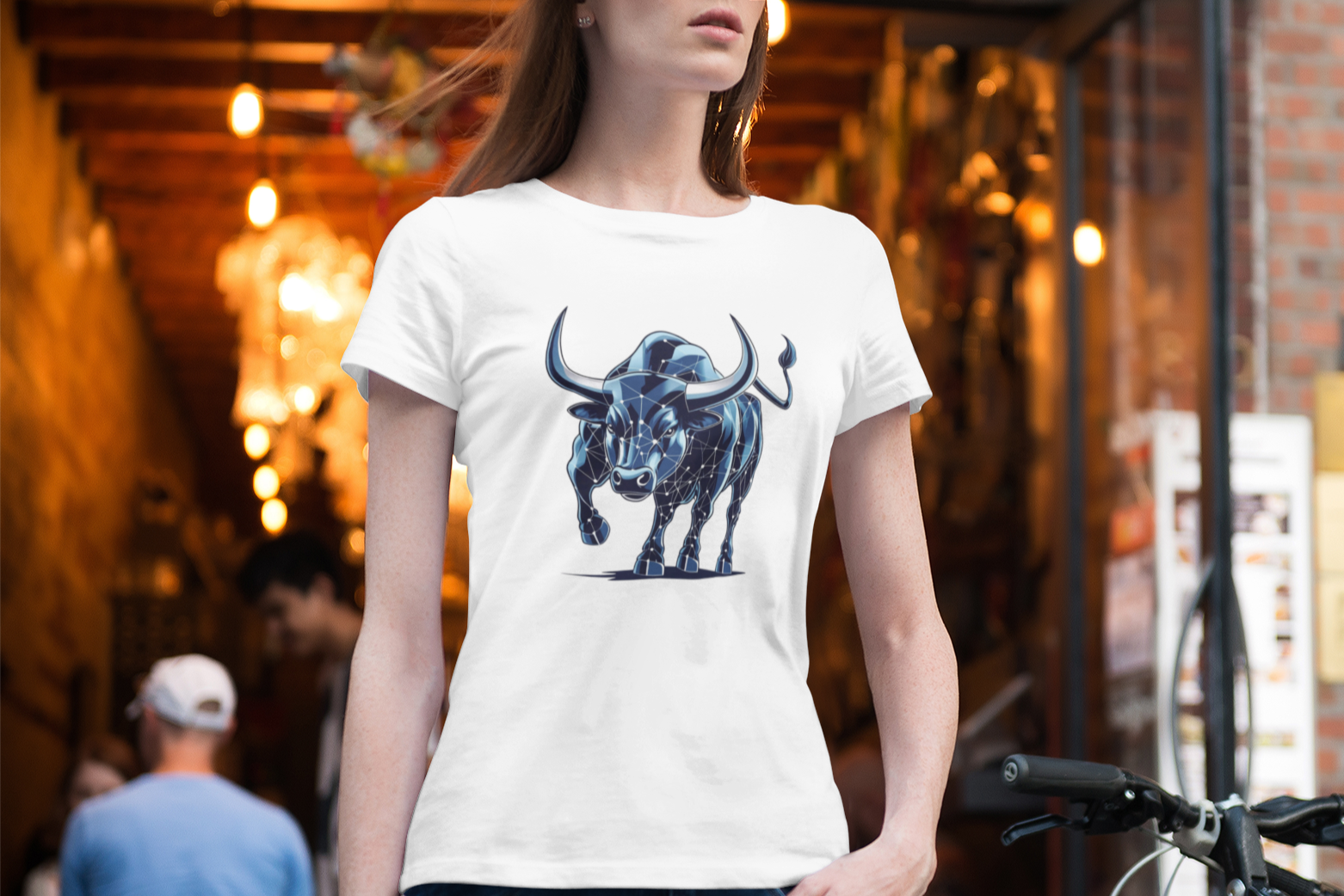 Person wearing a white t-shirt with a blue bull graphic in an urban setting