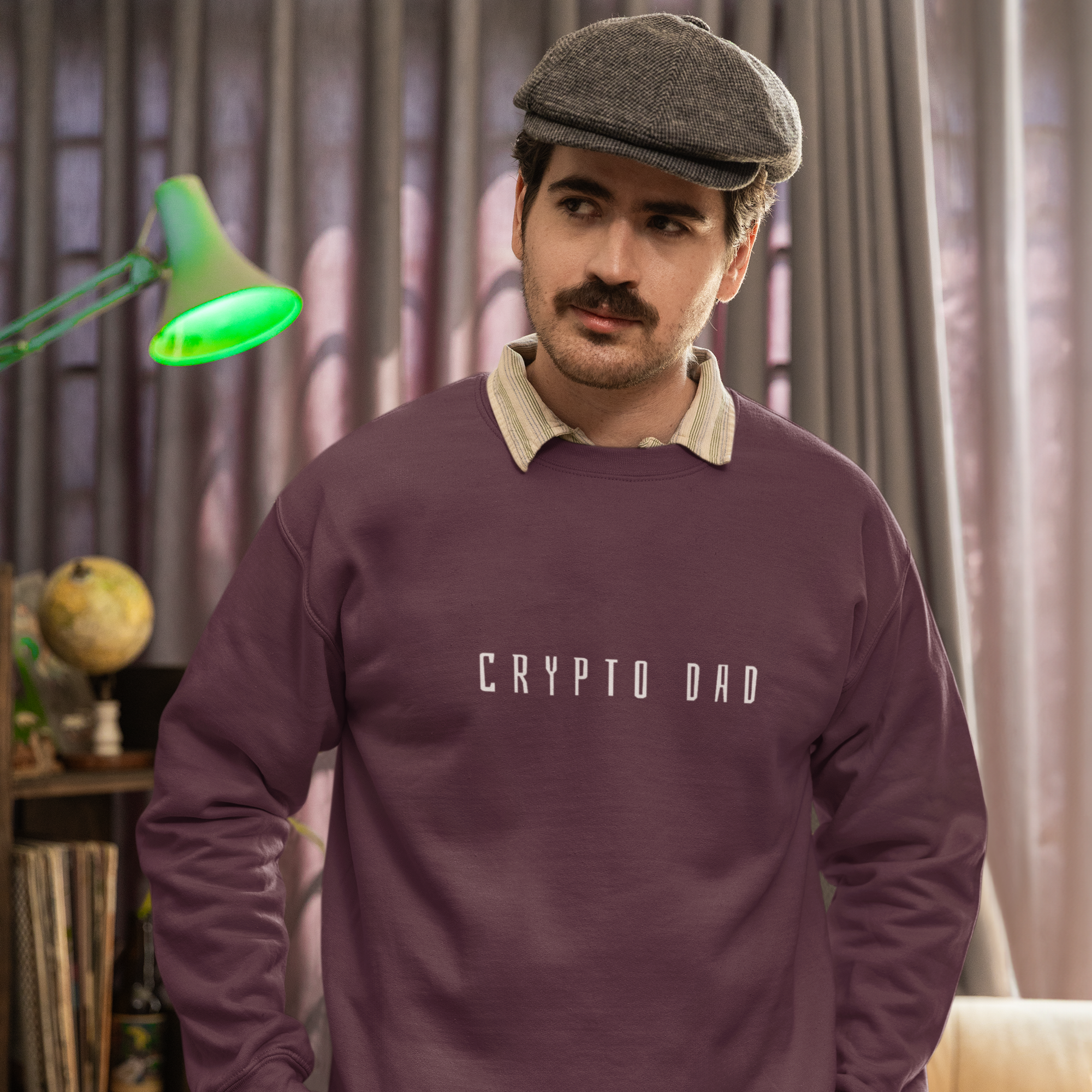 Man wearing a purple sweatshirt with 'CRYPTO DAD' text in a living room setting.