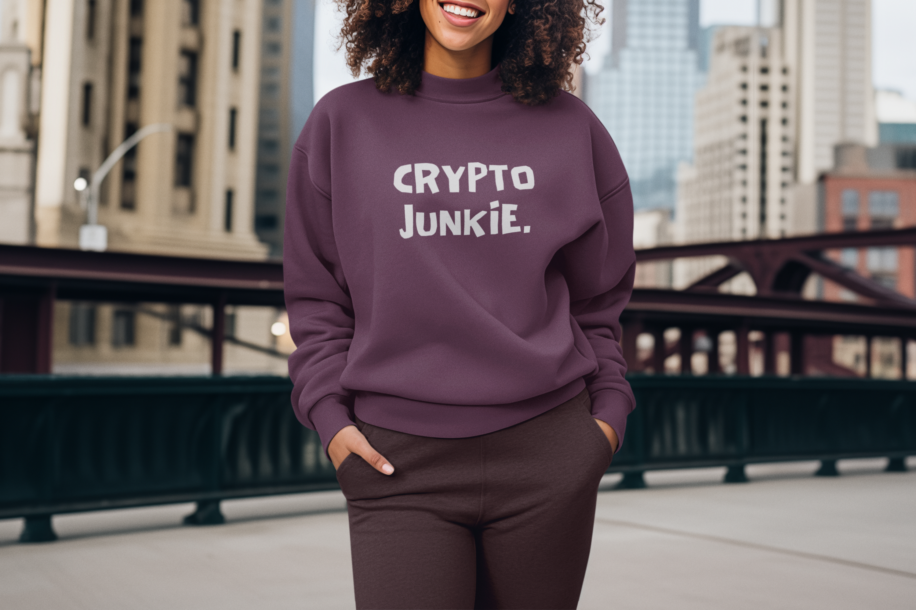 Person wearing a purple sweatshirt with 'CRYPTO JUNKIE' text, standing in an urban setting.