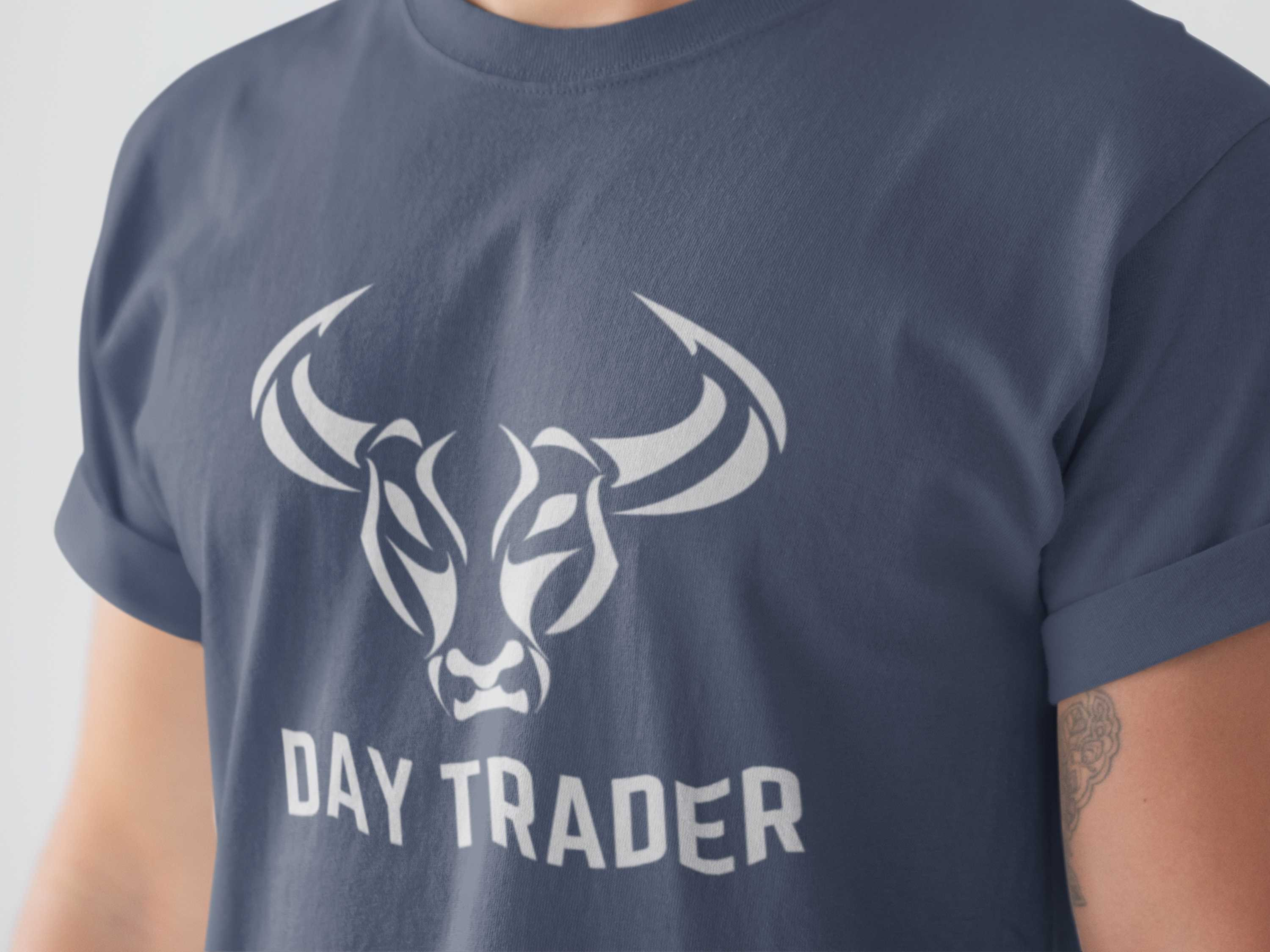 Navy blue t-shirt with a white bull logo and 'DAY TRADER' text on a plain background