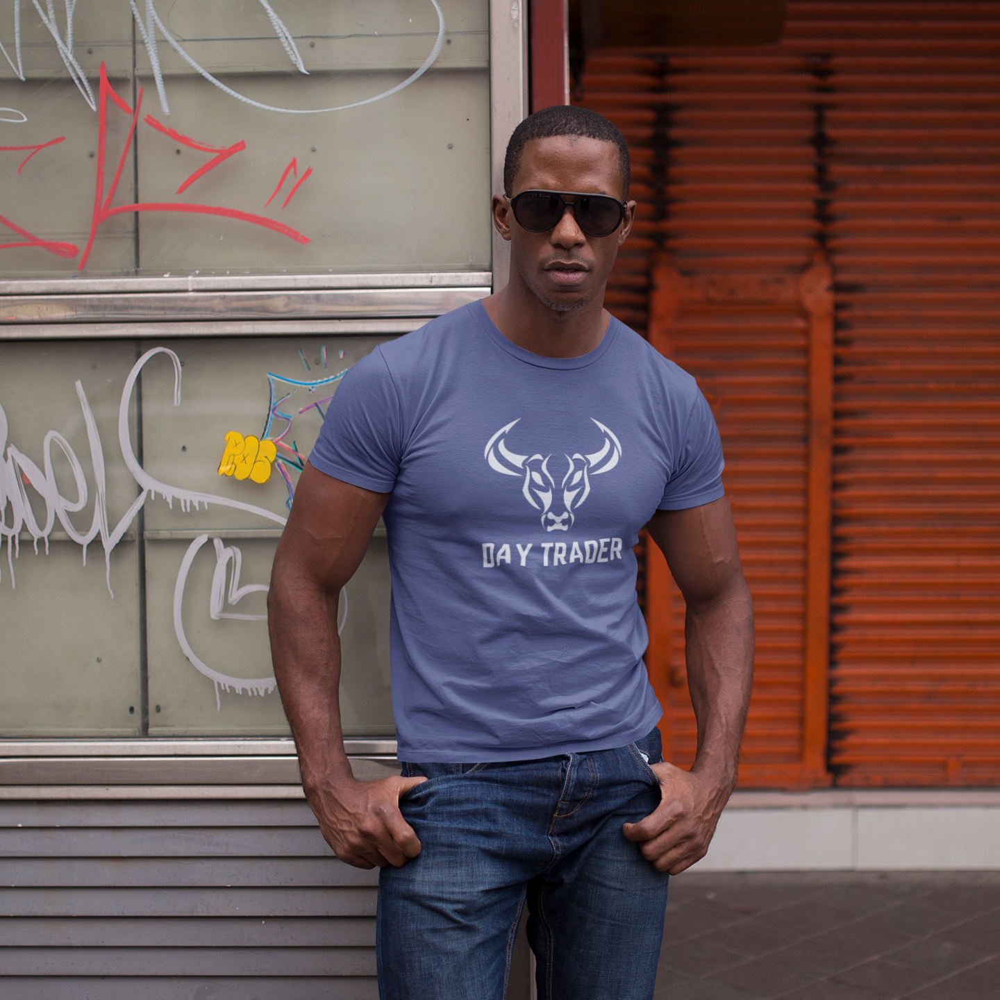 Man wearing a purple t-shirt with 'Day Trader' text and graphic, standing in front of a graffiti-covered wall.