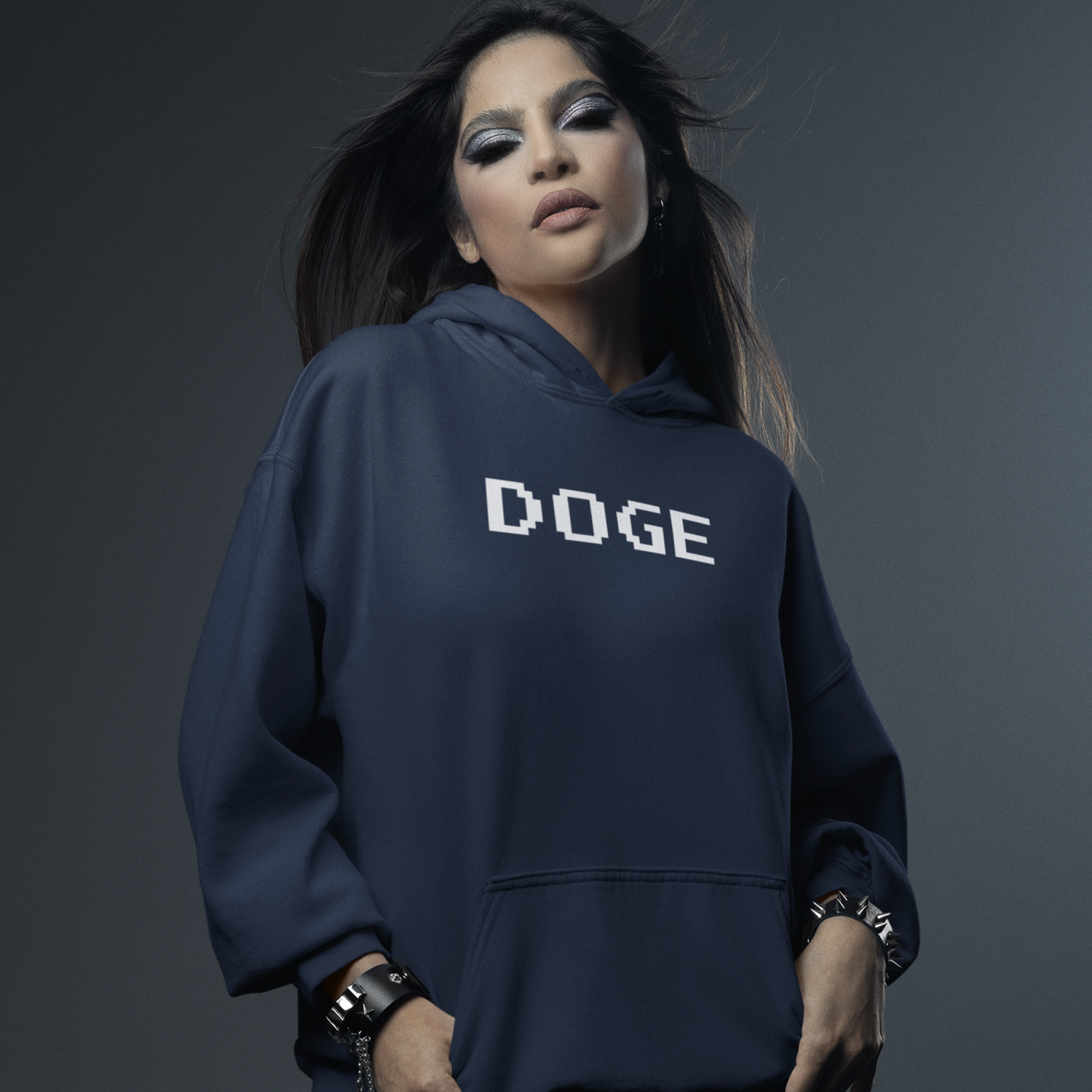 Person wearing a navy hoodie with 'DOGE' printed on it against a dark background