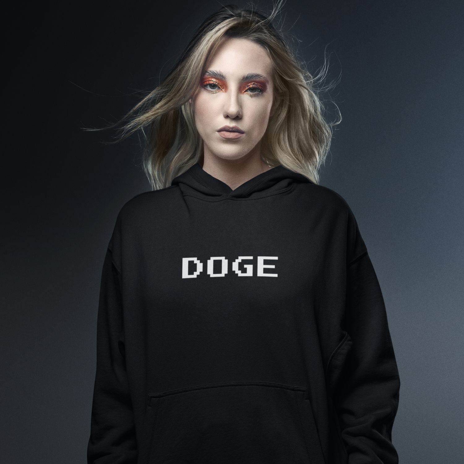 Person wearing a black hoodie with 'DOGE' text on a dark background