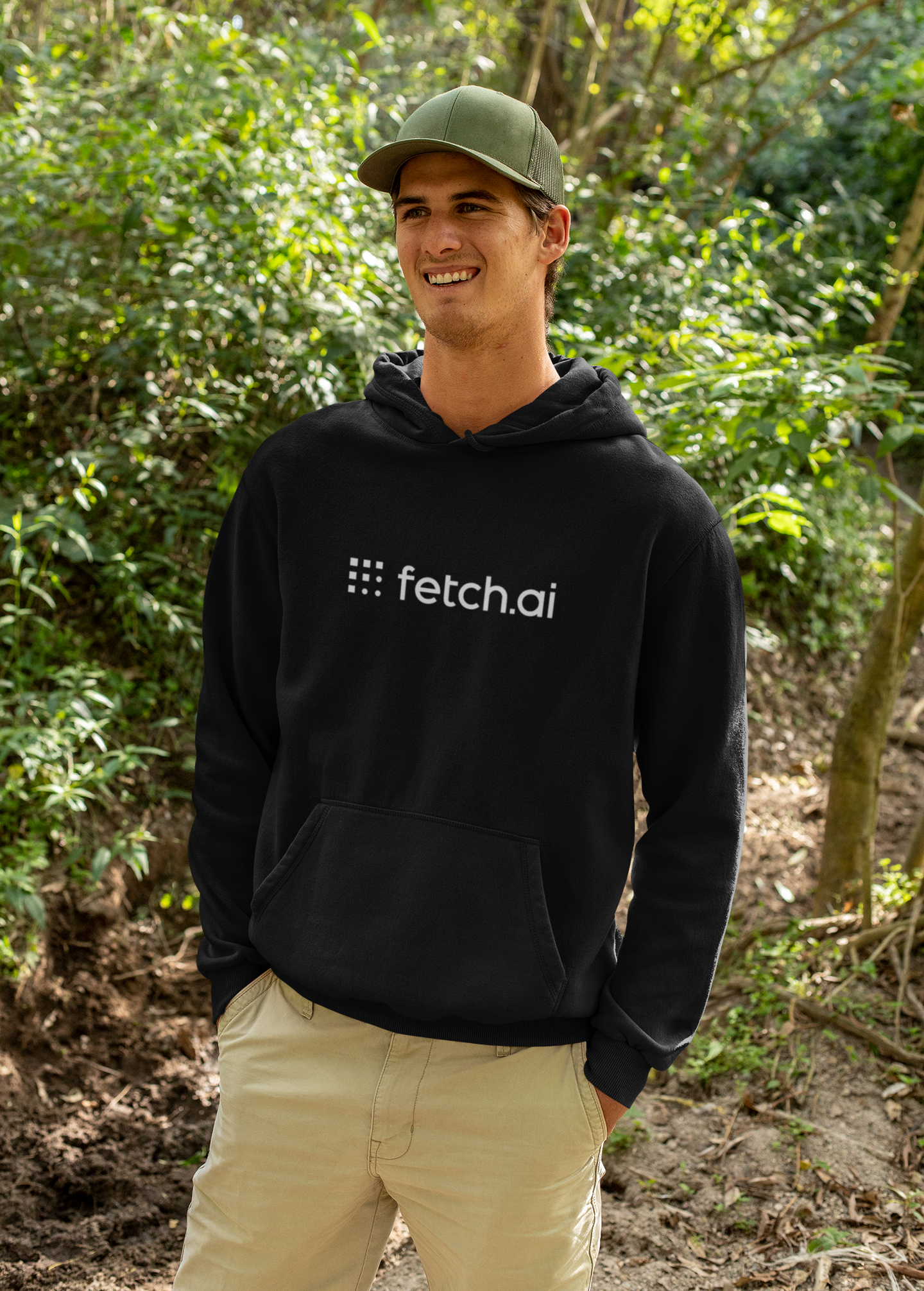 Person wearing a black hoodie with 'fetch.ai' logo in a forest setting