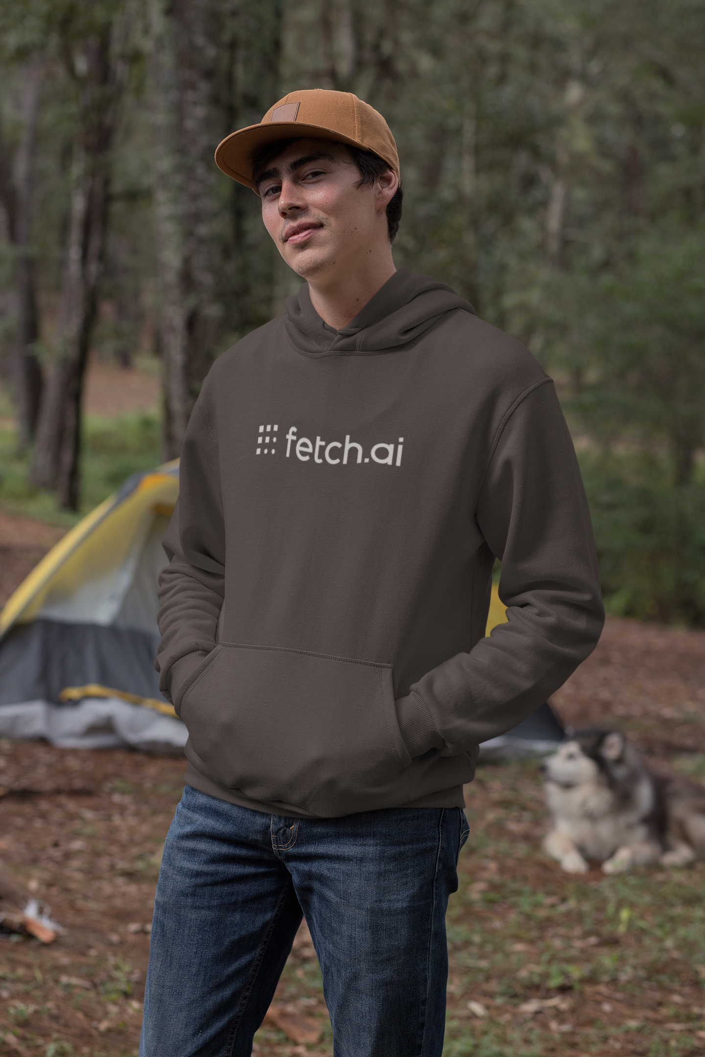 Person wearing a hoodie with 'fetch.ai' logo in a forest setting