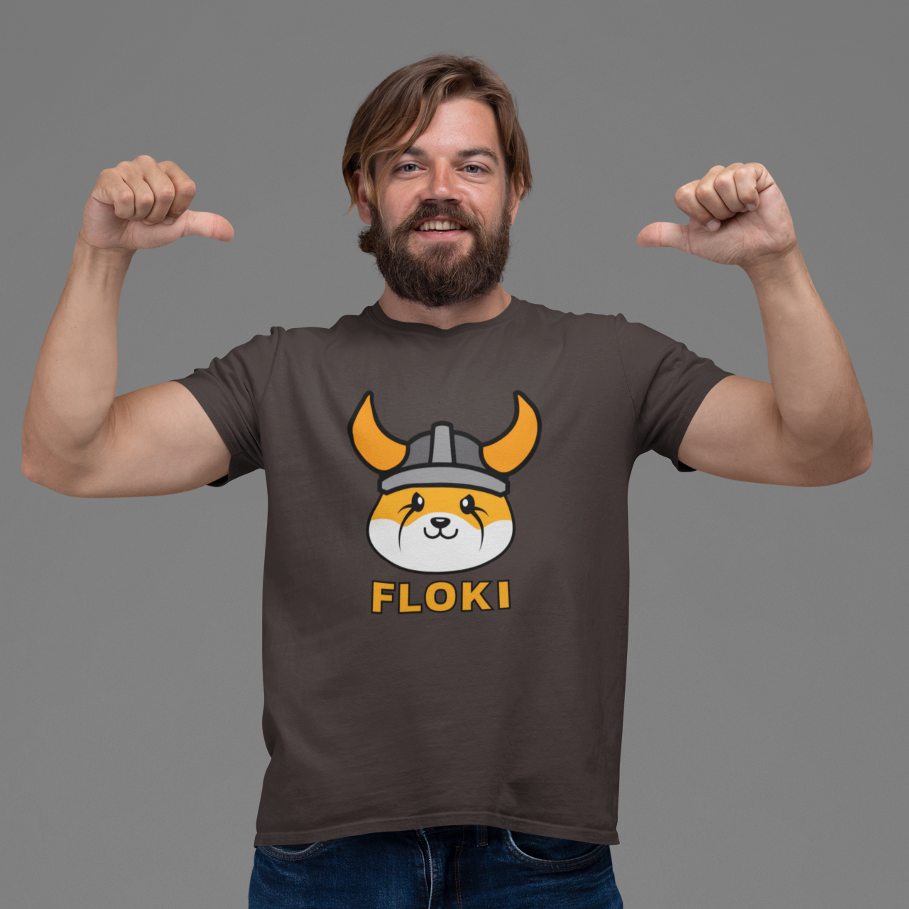 Man wearing a t-shirt with a dog graphic and 'FLOKI' text on a gray background
