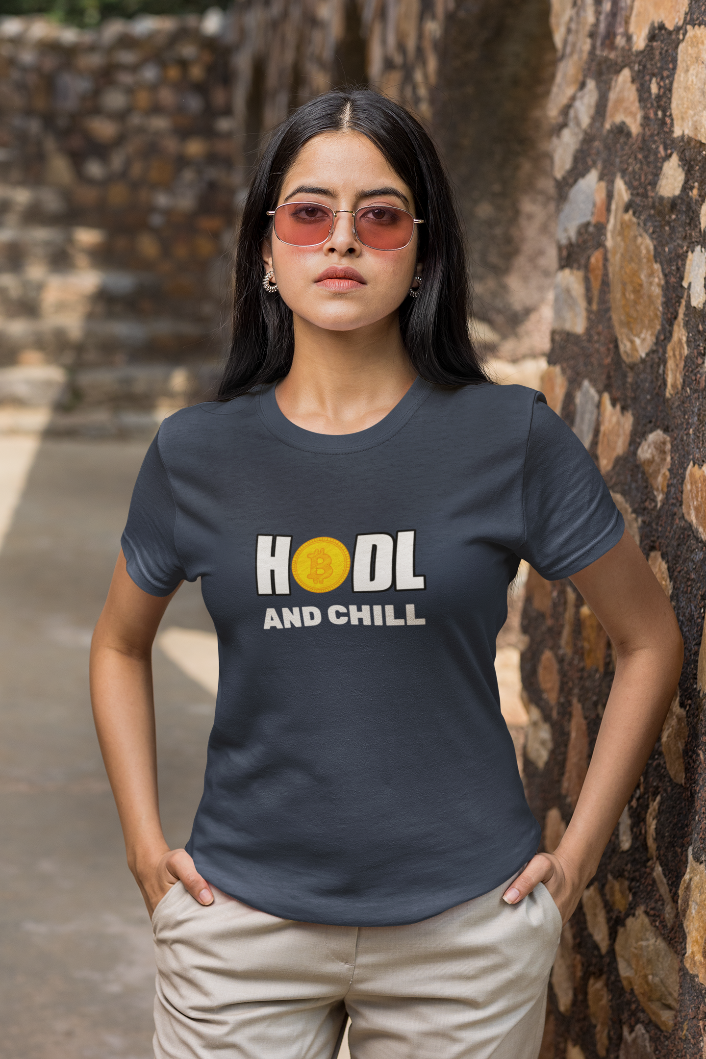 Woman wearing a t-shirt with 'HOOL AND CHILL' text in an outdoor setting.