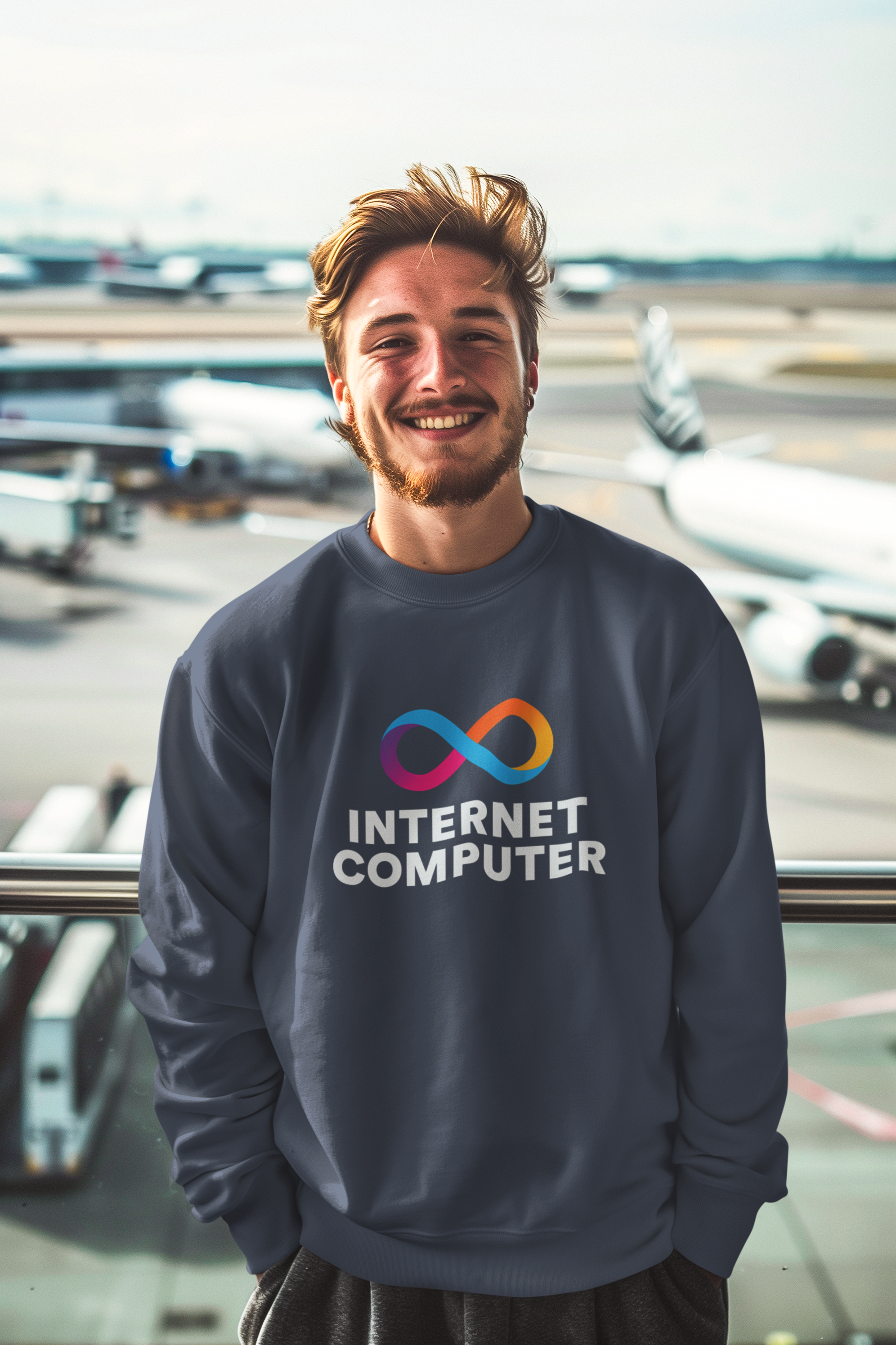 Person wearing a 'Internet Computer' sweatshirt with airplanes in the background
