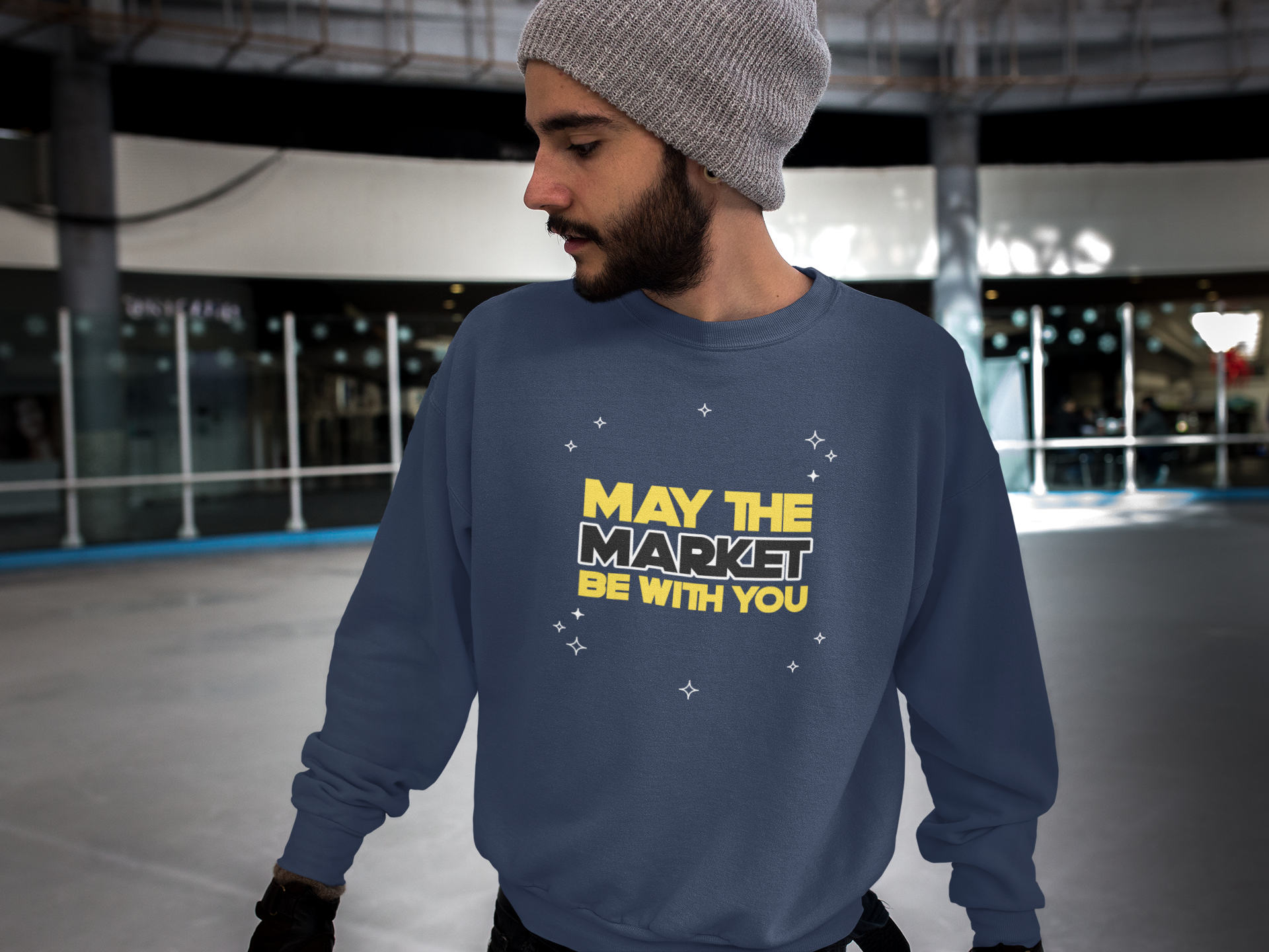 Person wearing a navy sweatshirt with yellow text in an indoor setting