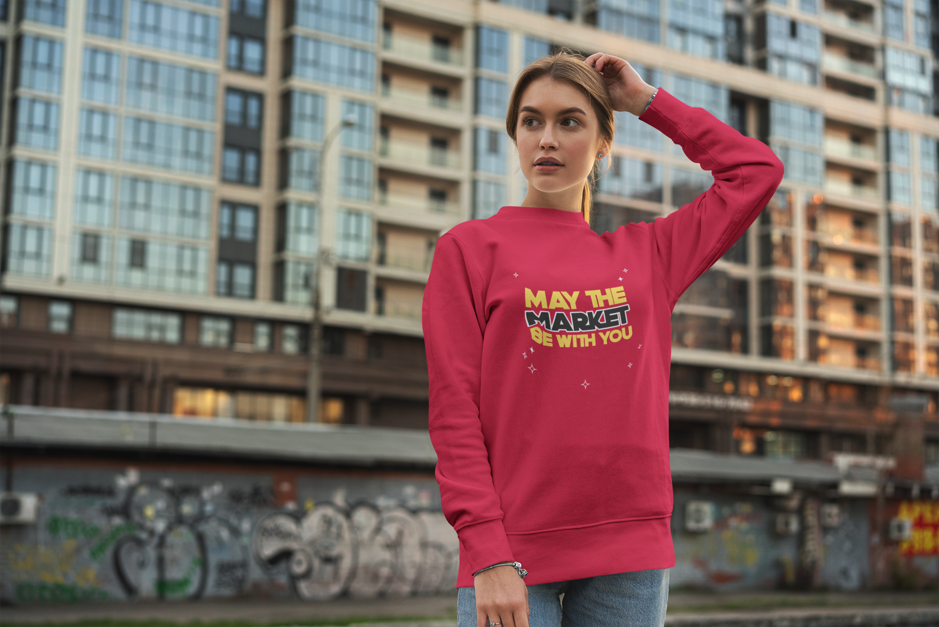 Person wearing a red sweatshirt with text in an urban setting