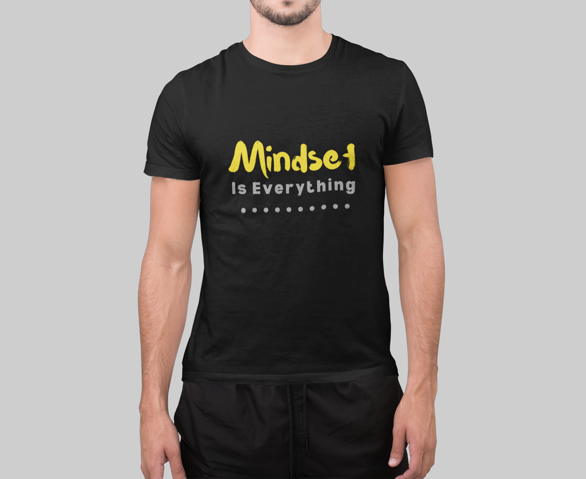 Person wearing a black t-shirt with 'Mindset Is Everything' text in yellow and white.