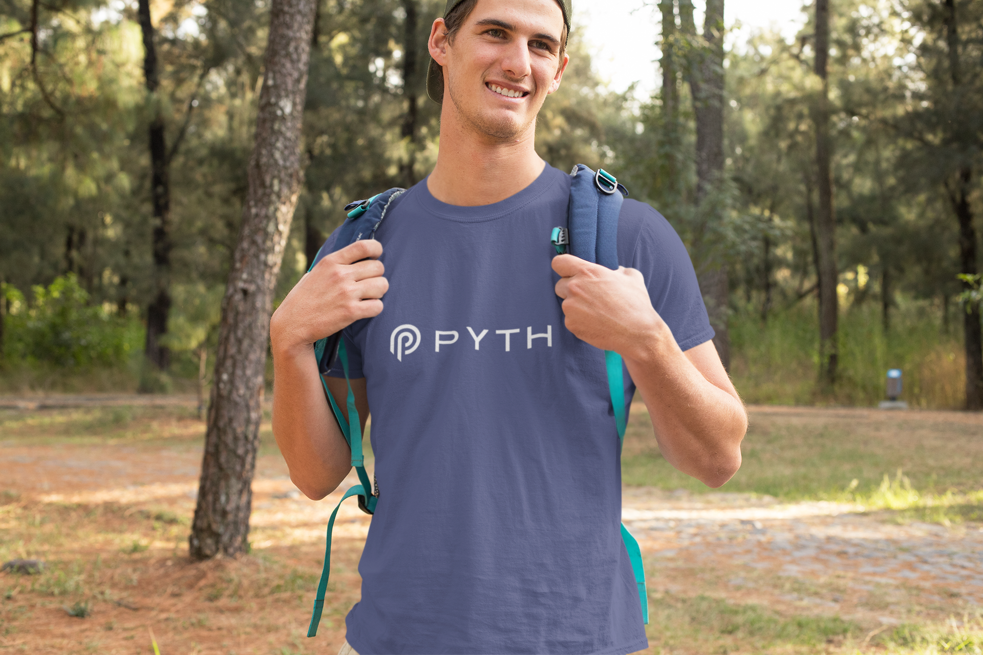 Man wearing a blue t-shirt with 'PYTH' logo outdoors