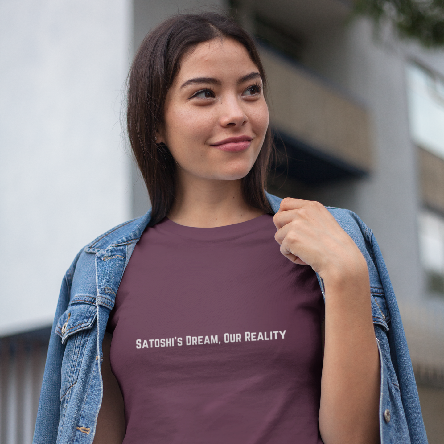 Woman wearing a purple t-shirt with text, standing outdoors.