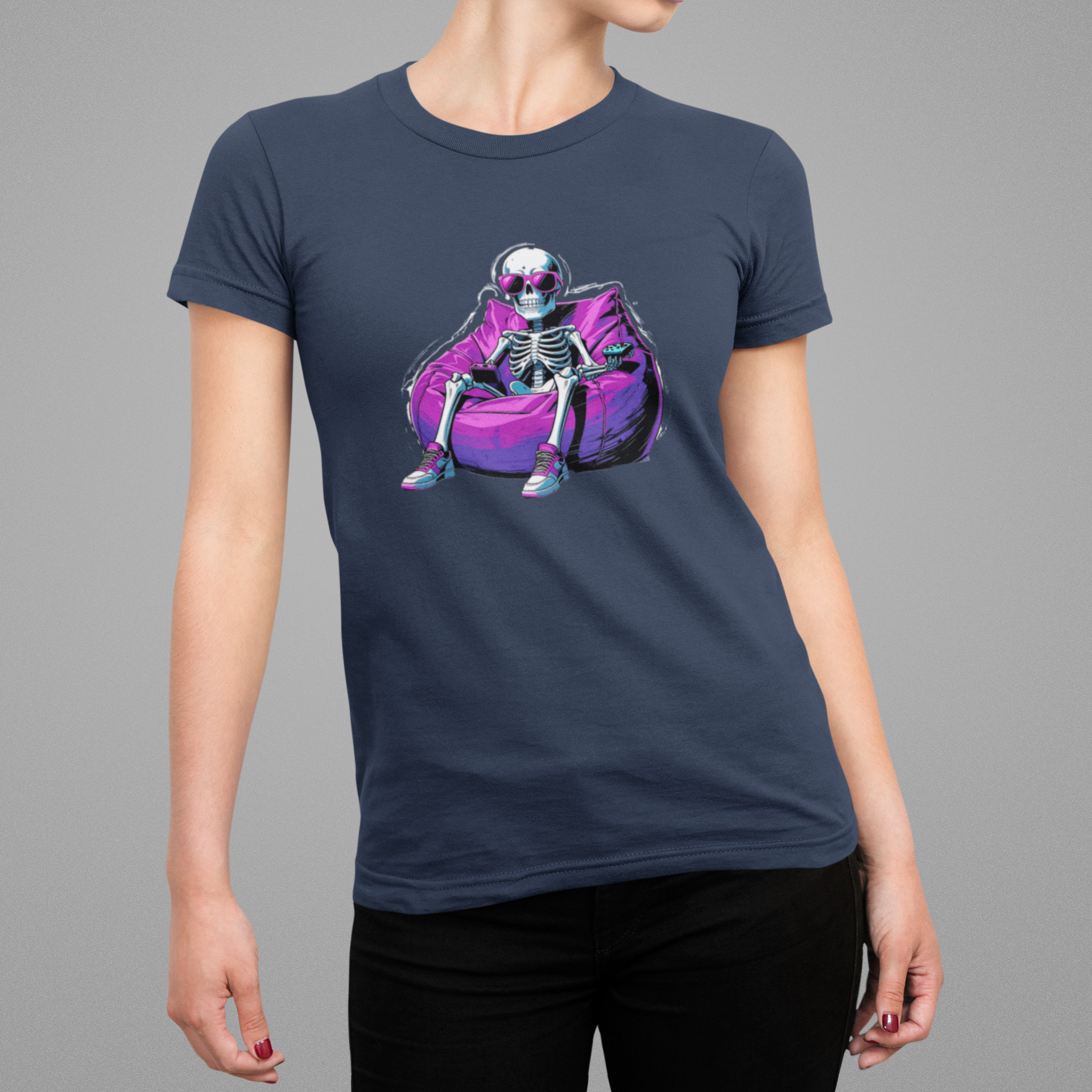 Woman wearing a navy blue t-shirt with a colorful skeleton design on a gray background