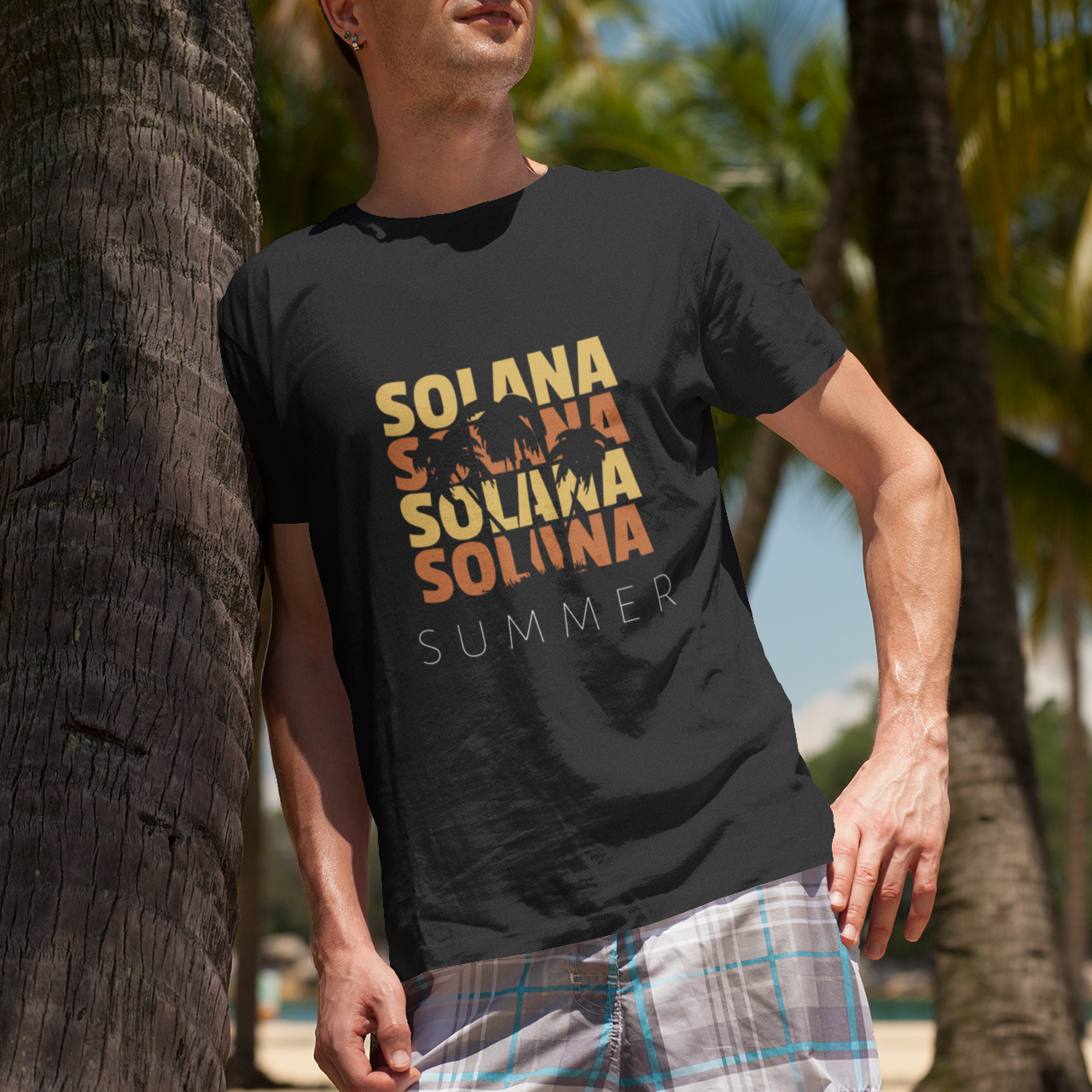 Person wearing a black t-shirt with 'Solana Summer' text standing next to palm trees.