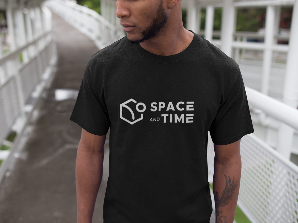 Person wearing a black t-shirt with 'Space and Time' logo outdoors.
