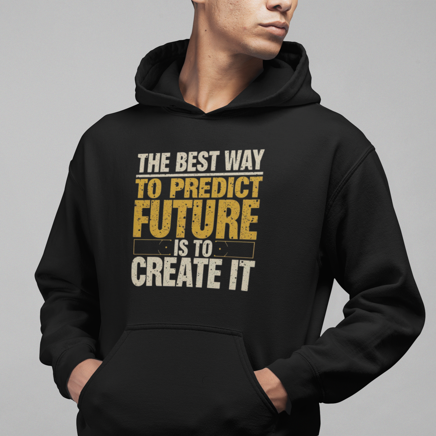 Person wearing a black hoodie with motivational quote on a gray background