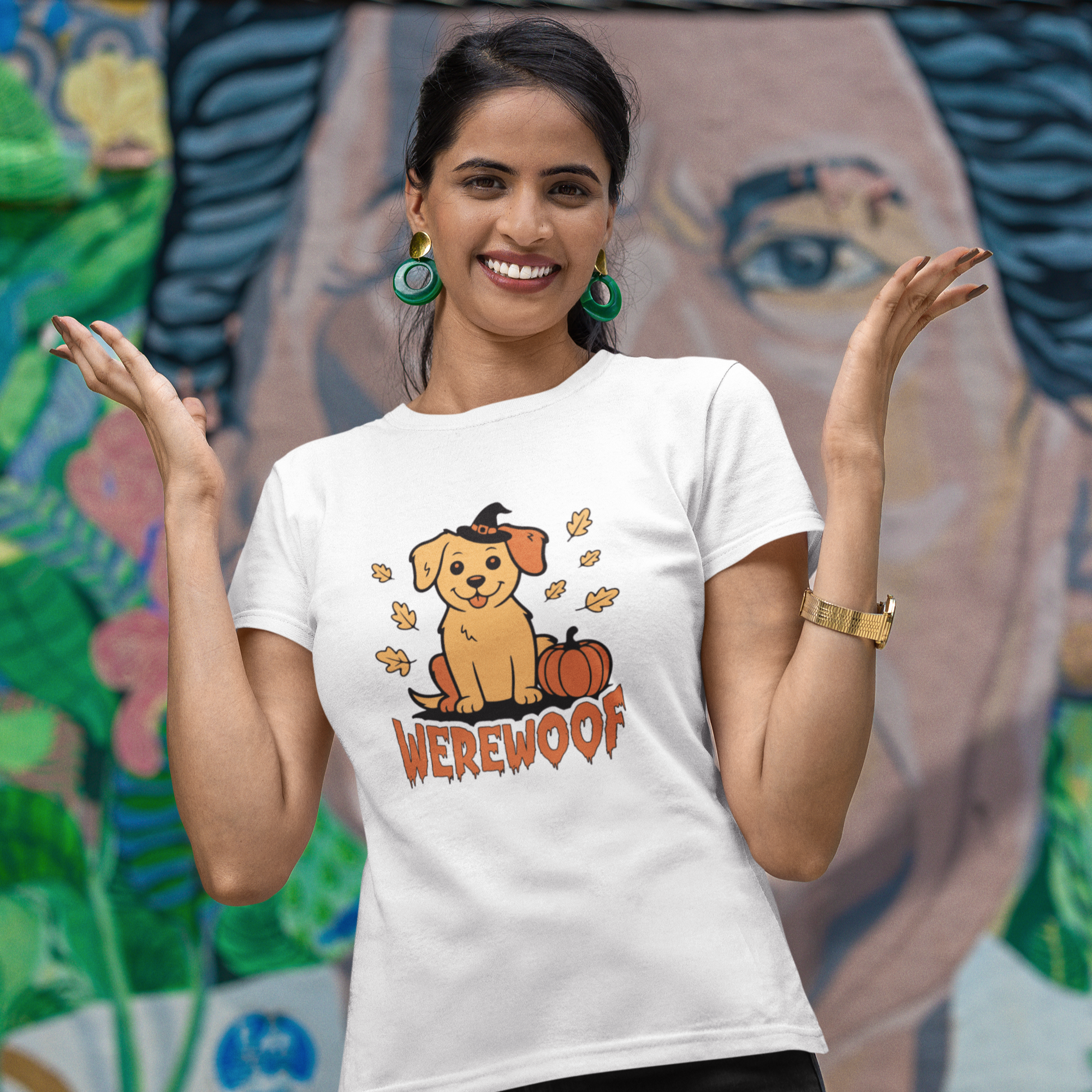 Woman wearing a white t-shirt with a dog graphic and 'WEREWOLF' text, standing in front of a colorful mural.
