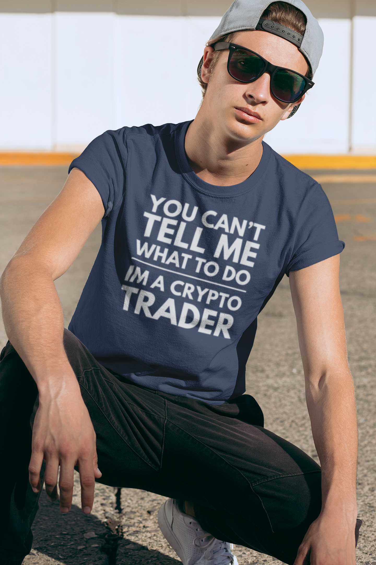 Person wearing a navy t-shirt with a motivational quote on it, sitting outdoors.