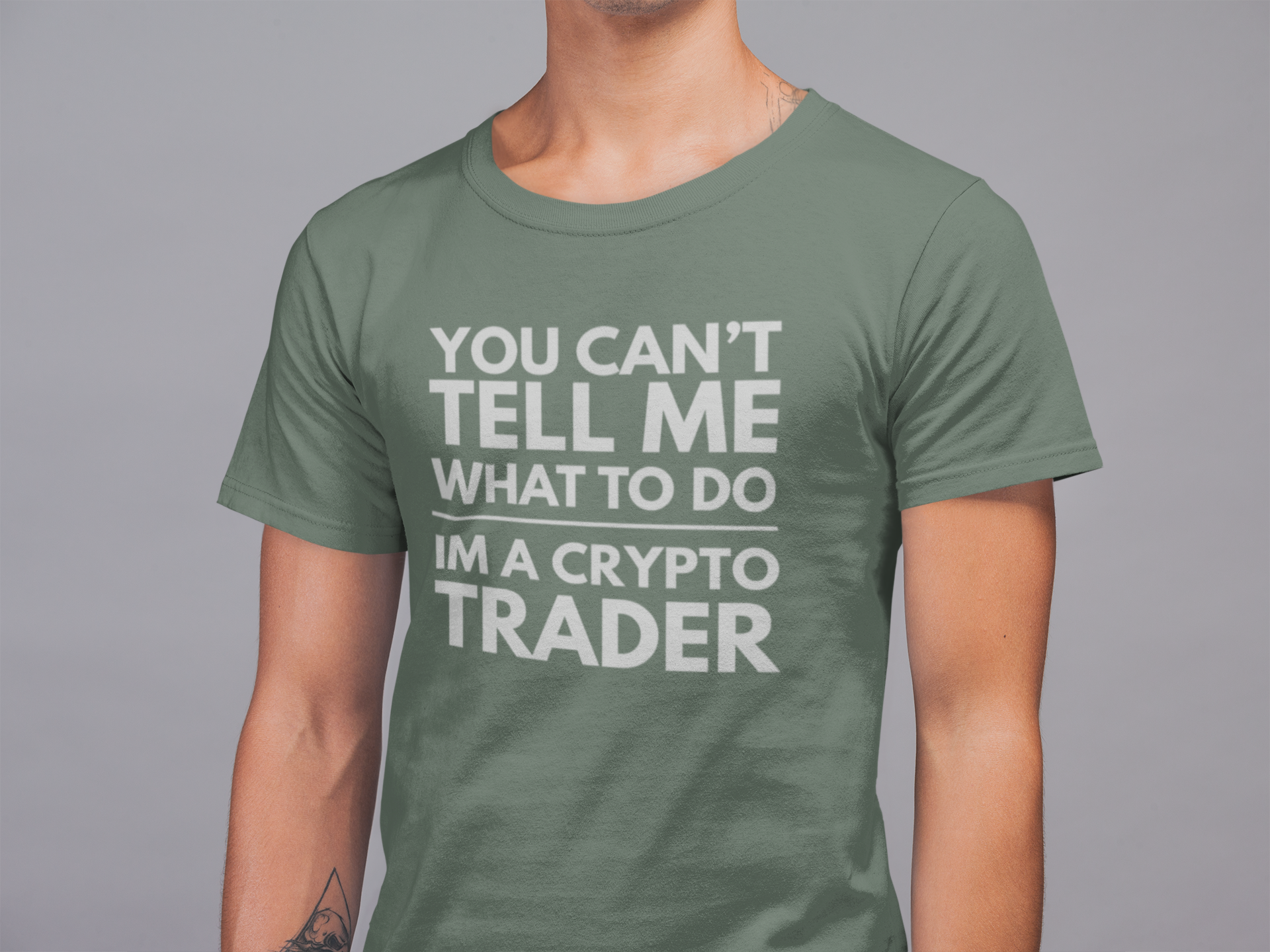 Person wearing a green t-shirt with a white text design on a gray background