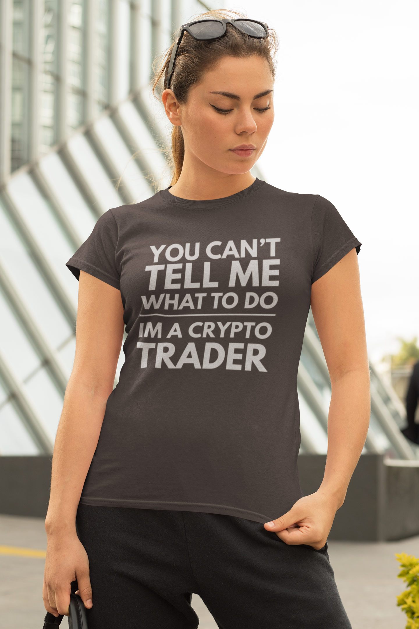 Woman wearing a t-shirt with a crypto trader message in an urban setting