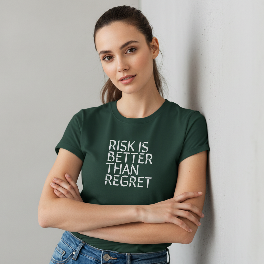 Woman wearing a green t-shirt with 'RISK IS BETTER THAN REGRET' text, standing against a plain background.