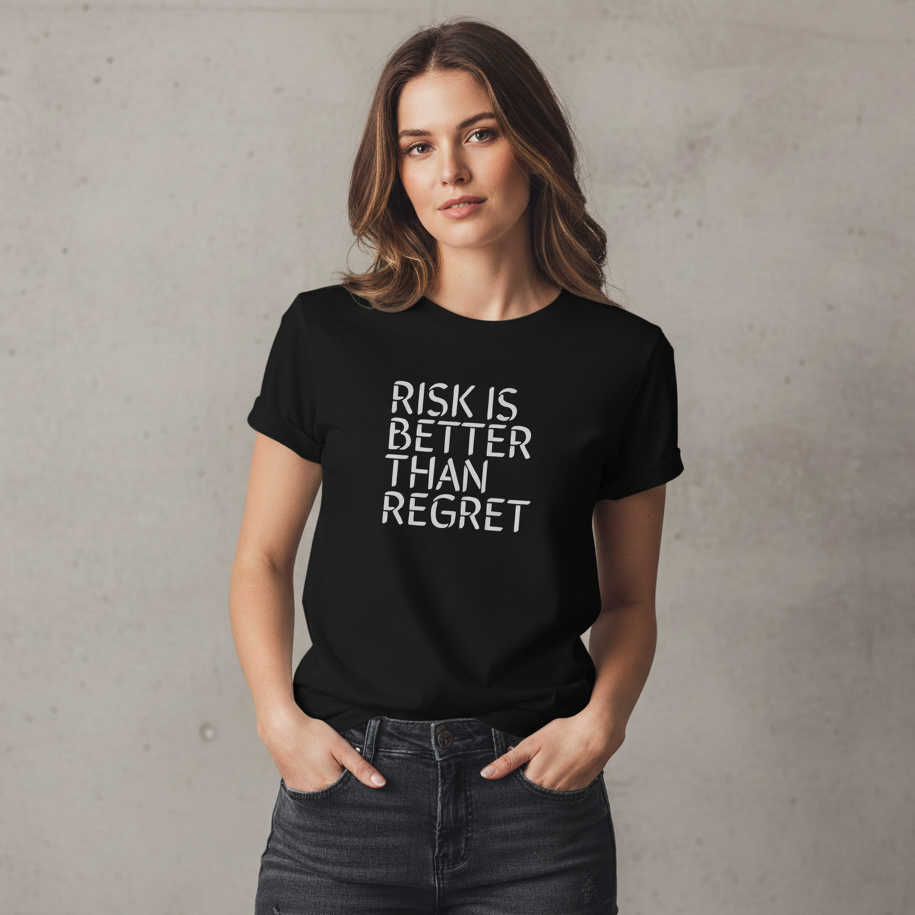 Woman wearing a black t-shirt with 'RISK IS BETTER THAN REGRET' text against a plain background