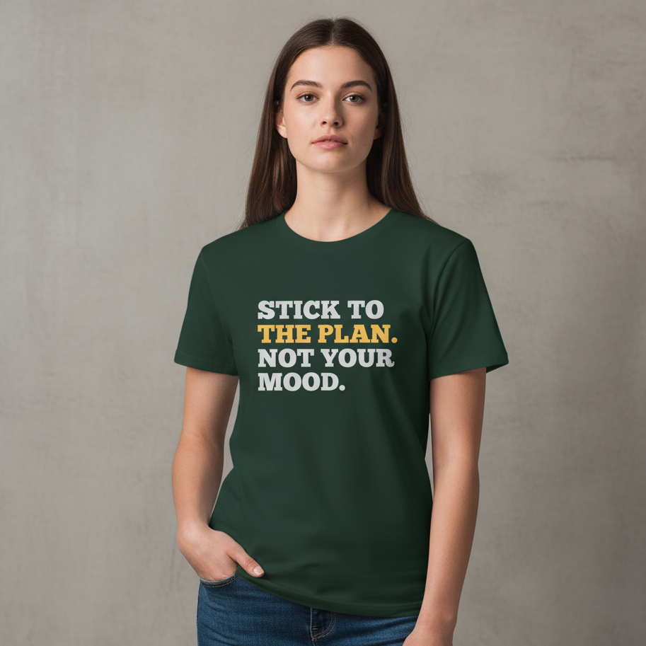 Person wearing a green t-shirt with motivational text against a plain background