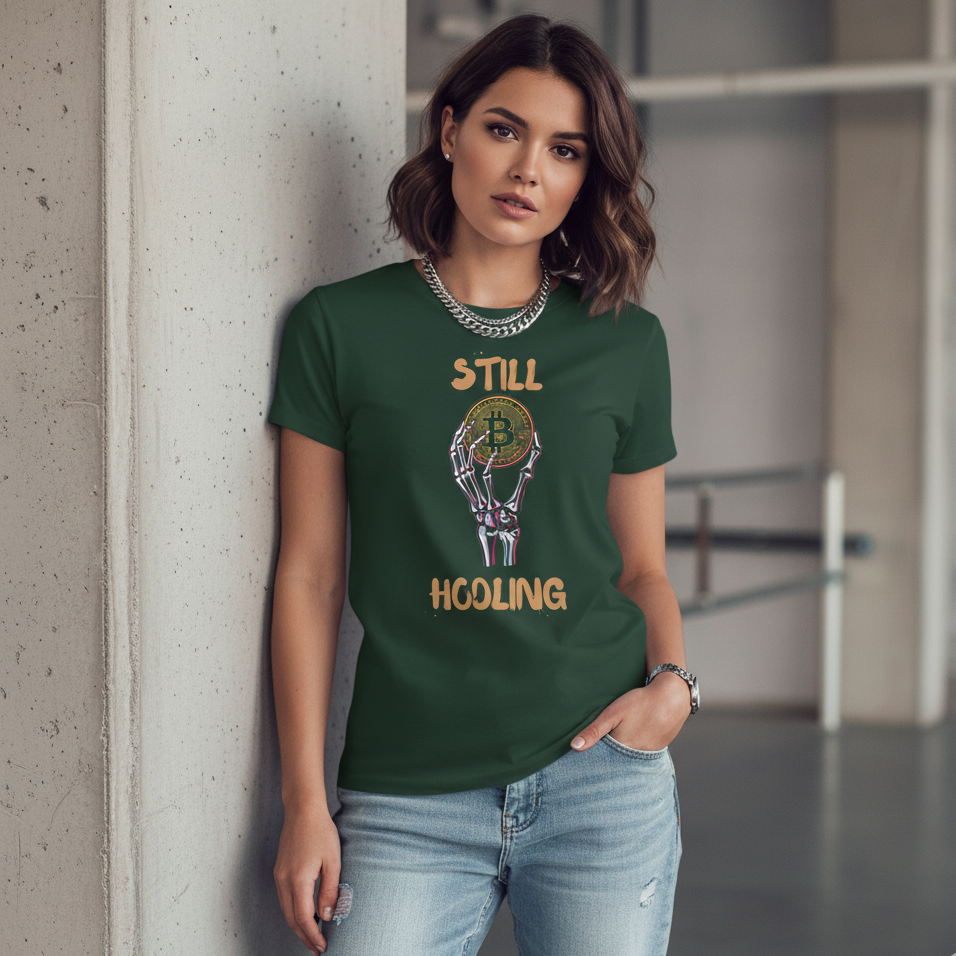 Woman wearing a green t-shirt with text and graphics, standing against a concrete wall.